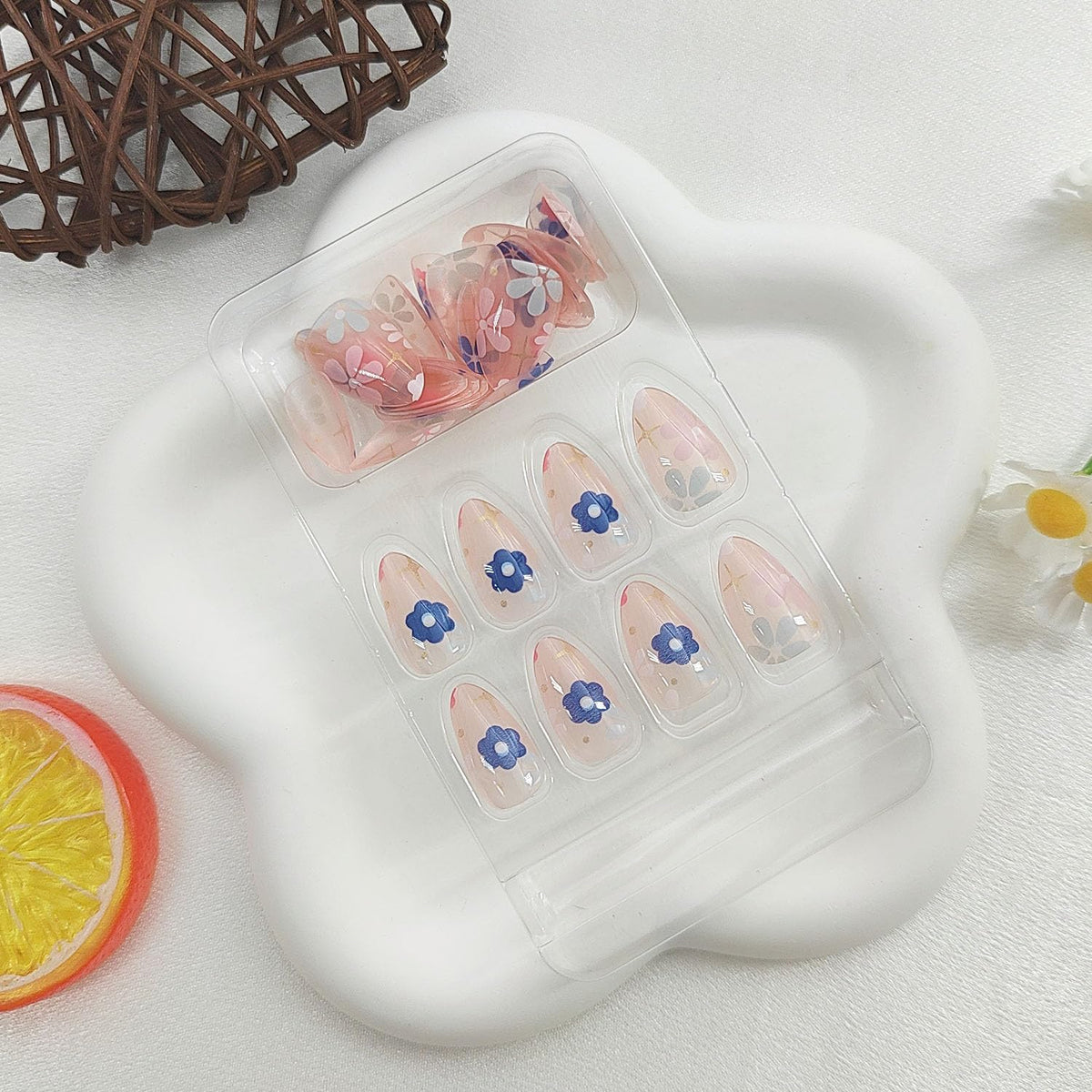 Close-up of MAOTTIE almond acrylic nails with wooden stick
