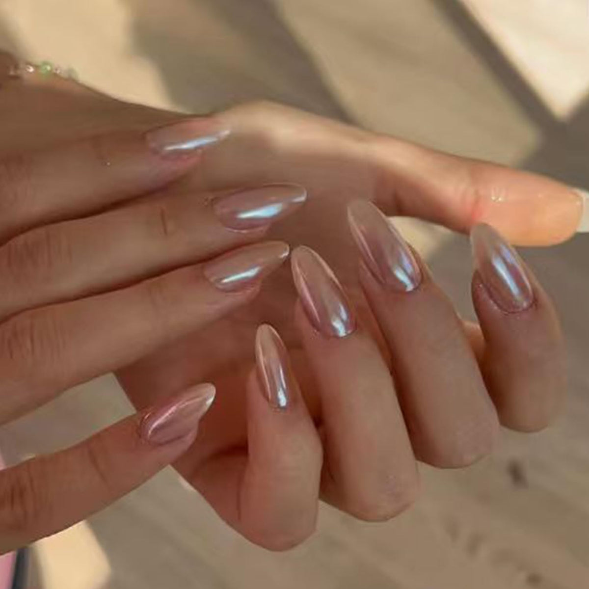 Close-up of Modelones Pink Chrome Press on Nails with adhesive tabs