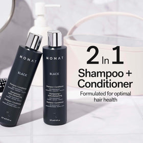 Close-up of MONAT Black Shampoo + Conditioner bottle