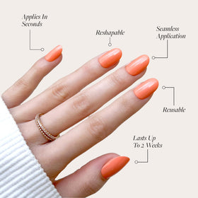 Close-up of orange opaque short round nails