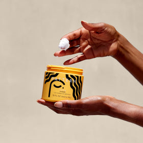 Close-up of PATTERN Styling Cream showing texture on fingers