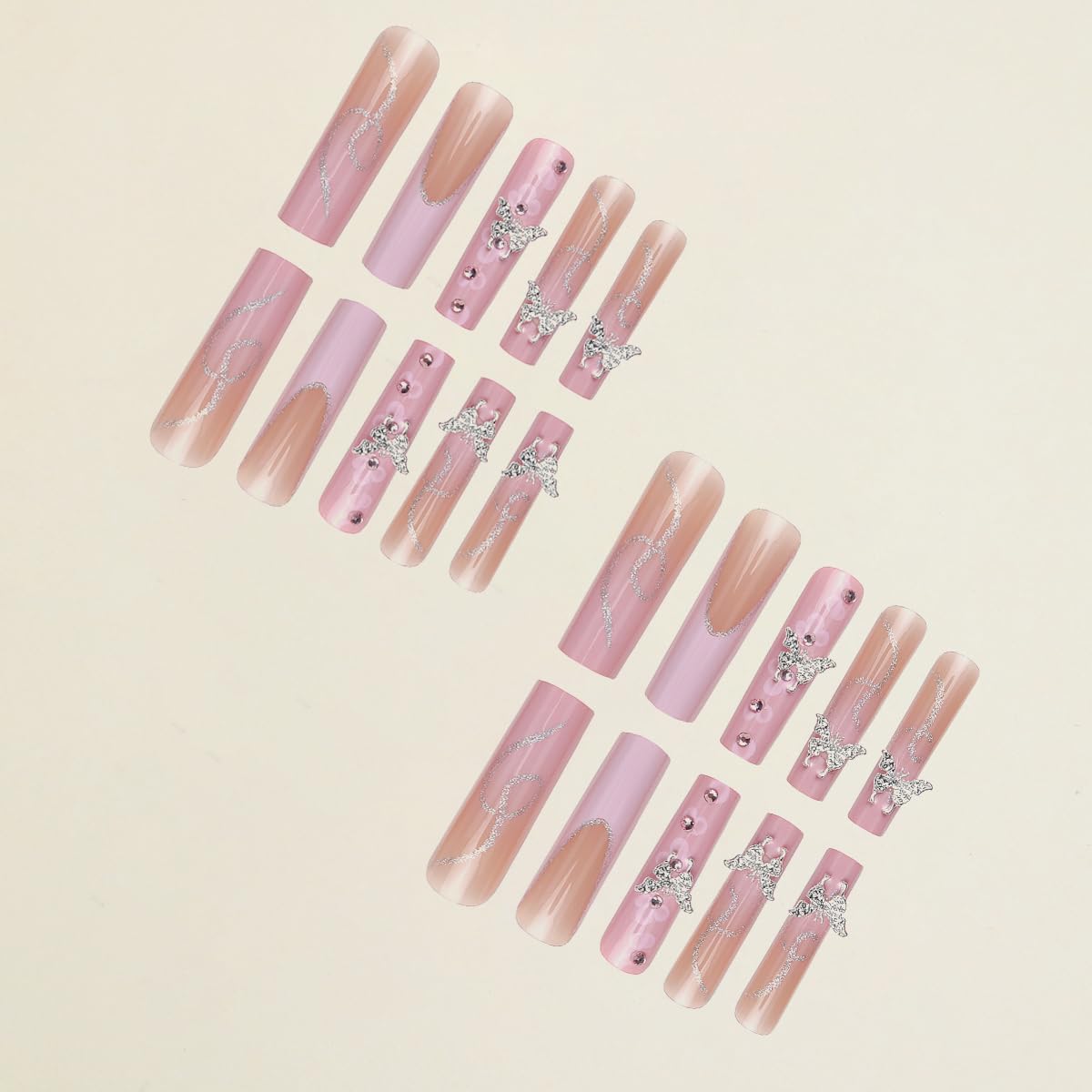 Close-up of pink French tip press on nails with butterfly charms