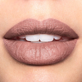 Close-up of REVLON Super Lustrous Mattes Lipstick bullet with embossed design