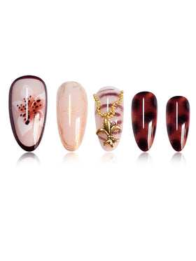 Close-up of SEENEEY press on nails showing gold charm details