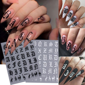 Close-up of STZPRONAIL alphabet nail stickers on a manicure