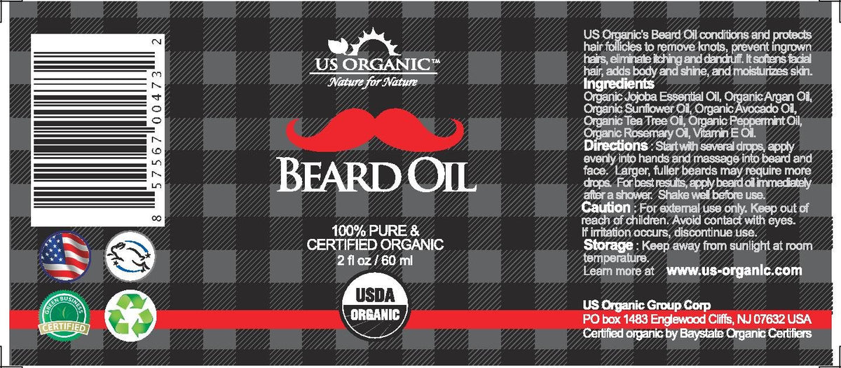 Close-up of US Organic Beard Oil ingredients on a wooden surface