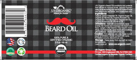 Close-up of US Organic Beard Oil ingredients on a wooden surface