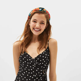 Close-up of VELSCRUN knotted headband showing soft fabric