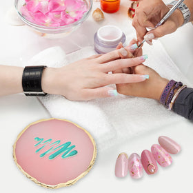 Close-up of white resin nail art palette with gold trim