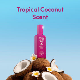 Coco & Eve Coconut Milk Body Sunscreen SPF 50 bottle on a beach
