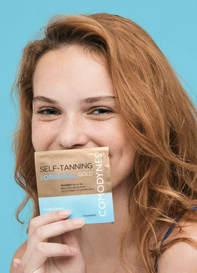 Comodynes Self-Tanning Wipes individual towel being used