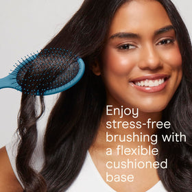 Conair detangling brush in use on wet hair