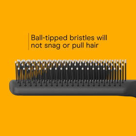 Conair hairbrush in use on long hair