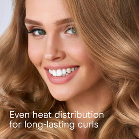 Conair Instant Heat Curling Iron Brush on a vanity with hair styling products