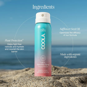 COOLA Organic Sunscreen Spray SPF 50 Guava Mango in hand for application