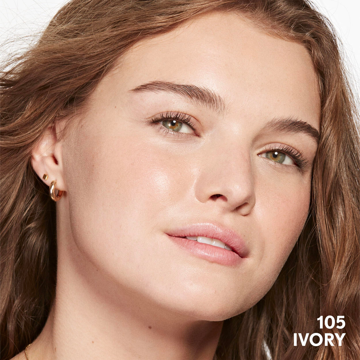 COVERGIRL Clean Invisible Foundation 1oz on a vanity with flowers
