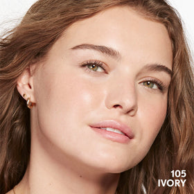COVERGIRL Clean Invisible Foundation 1oz on a vanity with flowers