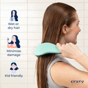 Crave Naturals Biggie Glide Thru Hair Brush held in hand for scale