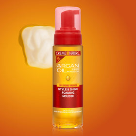 Creme of Nature mousse on a vanity with other hair products