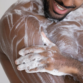 Cremo Blue Cedar & Cypress Body Wash in a bathroom setting