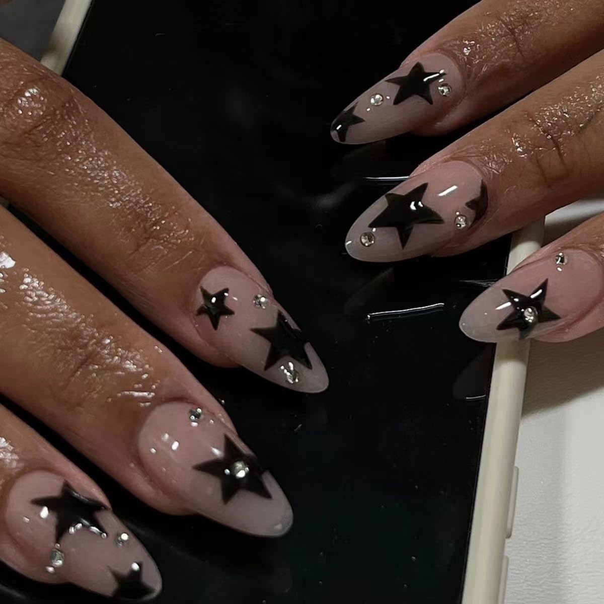 CTTHNBD Press on Nails Almond medium black star design front view