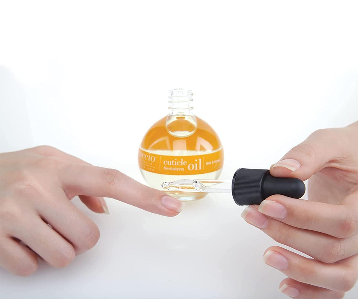 Cuccio Milk & Honey Cuticle Oil with hands in background