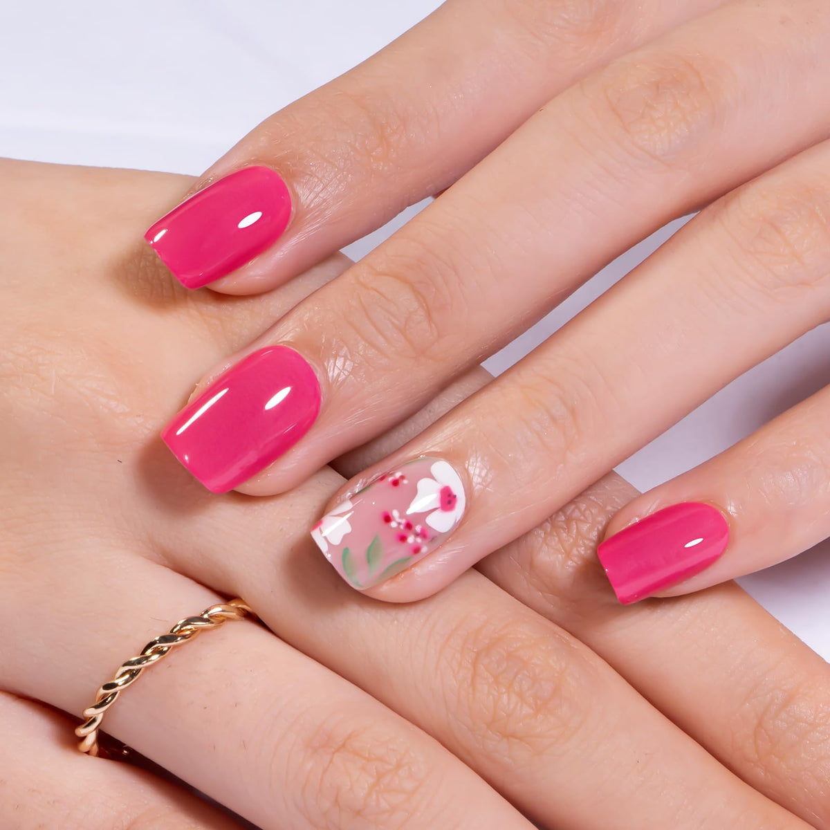 CurvLife press on nails in a hand with a floral background