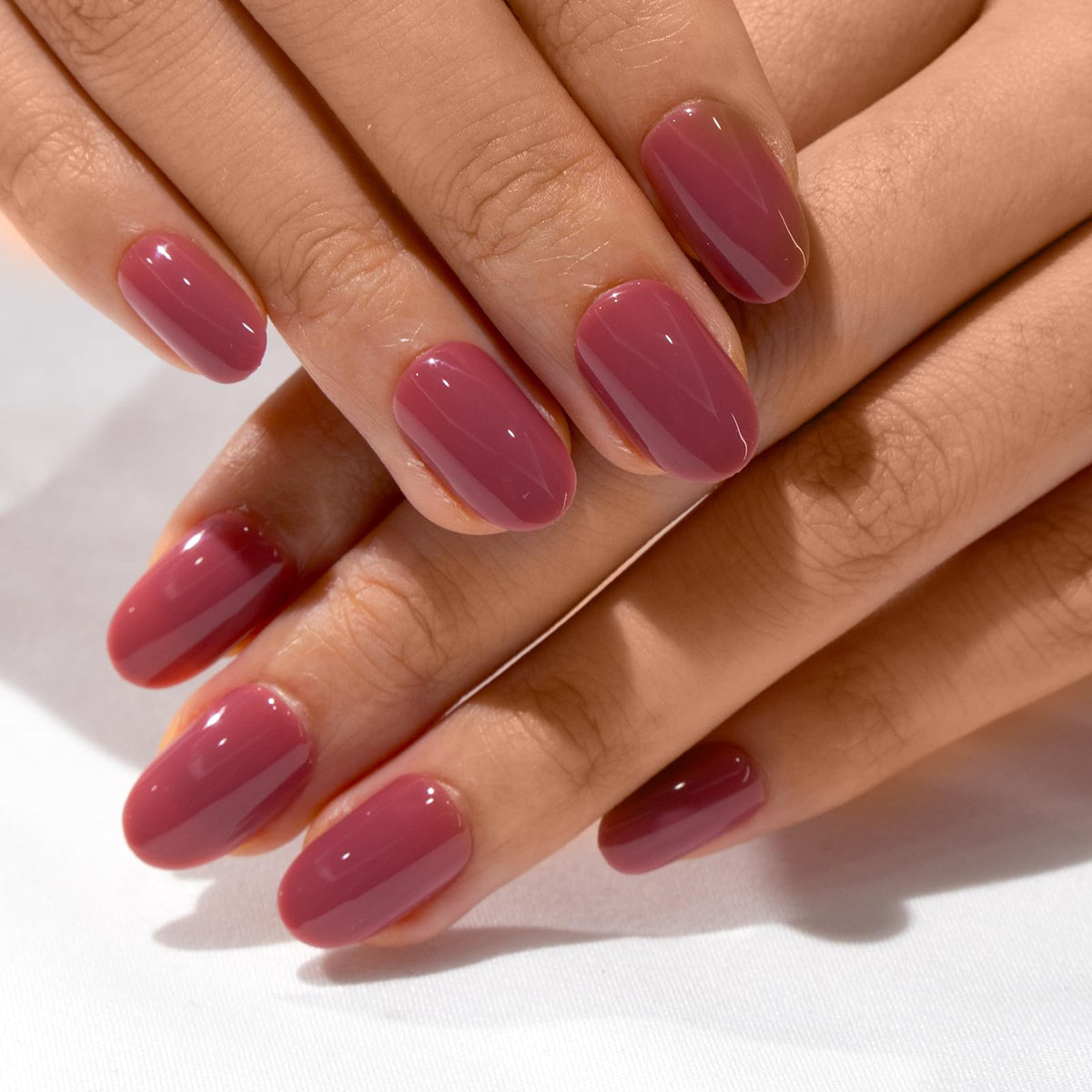 CurvLife Short Oval Press On Nails displayed with nail glue and file