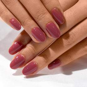 CurvLife Short Oval Press On Nails displayed with nail glue and file