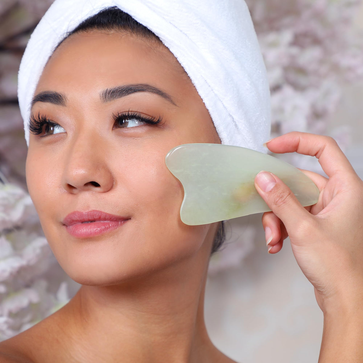 DAILY CONCEPTS Gua Sha Jade Facial Tool on a skincare table