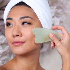 DAILY CONCEPTS Gua Sha Jade Facial Tool on a skincare table