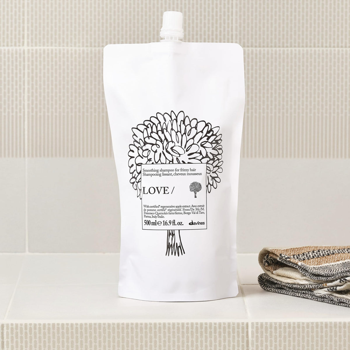 Davines LOVE SMOOTHING Shampoo refill on a bathroom shelf