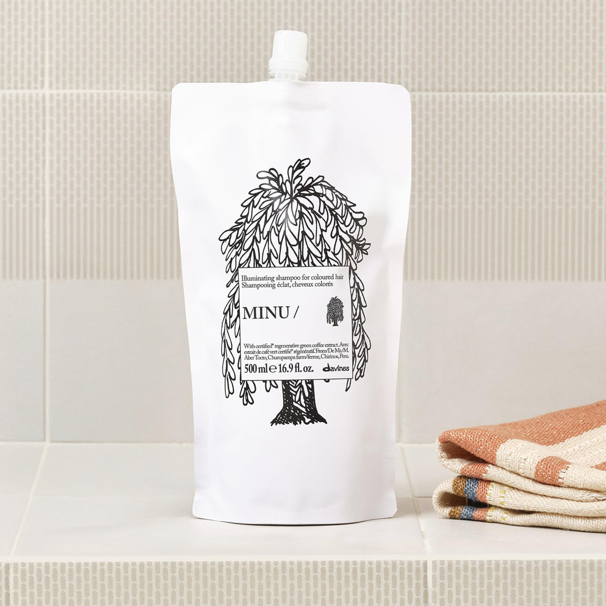 Davines MINU Shampoo refill pouch in a bathroom setting