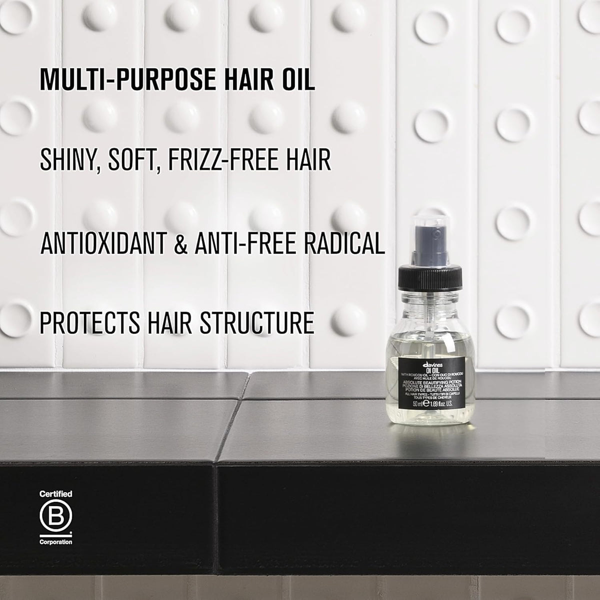 Davines OI Oil 60g with a textured hair background