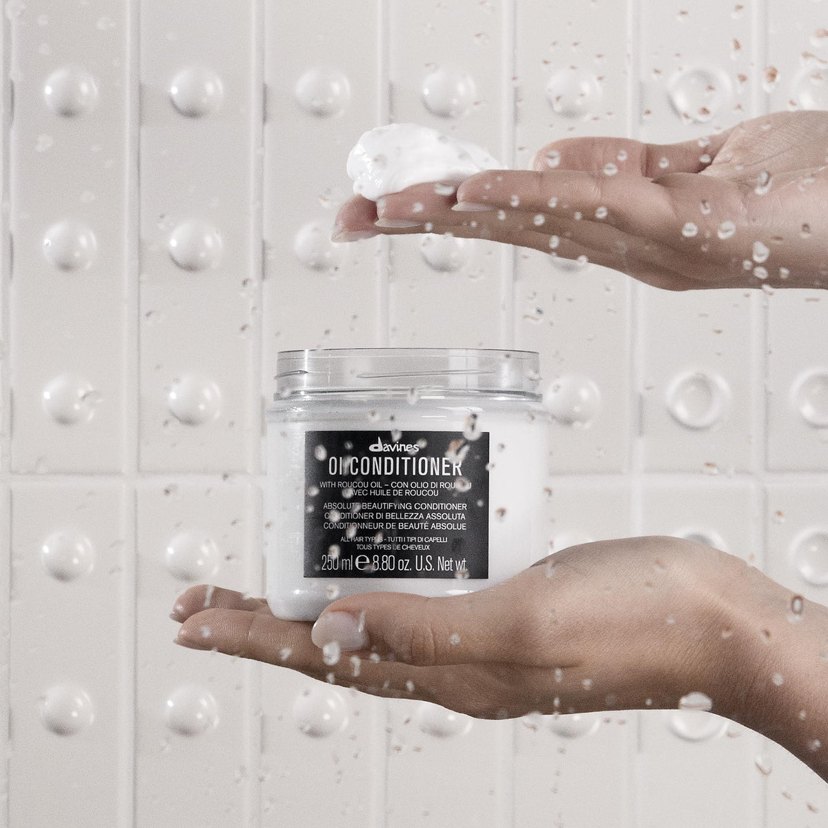 Davines OI Softness & Shine Trio set displayed with fresh flowers