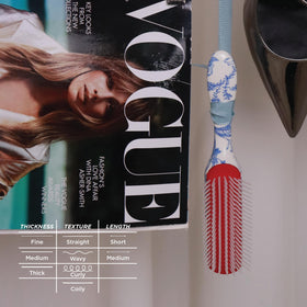 Denman D3 brush lifestyle scene with hair products