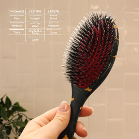 Denman D81M Boar Bristle Hair Brush on a styling table