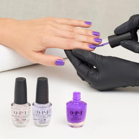 Display of OPI Glowin' on Vacay nail polish with summer accessories