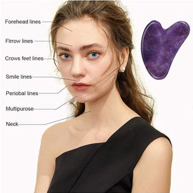 Ditind Gua Sha tool being used on a woman's face