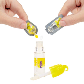 DIY lip gloss kit components including liquids and stirring spoon
