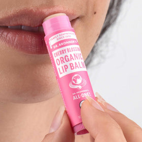 Dr. Bronner's Organic Lip Balm Cherry Blossom on a wooden surface