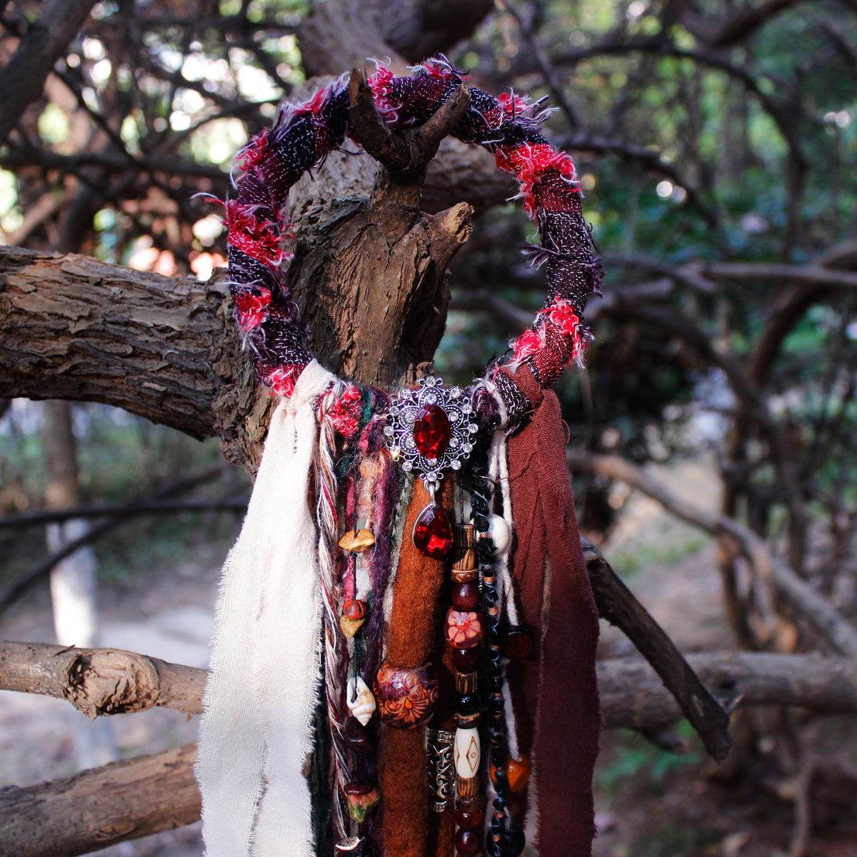 Dreadlock hair tie with various natural materials highlighted