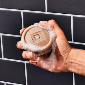 Duke Cannon Bar Soap Puck Buck Moon on a wooden surface