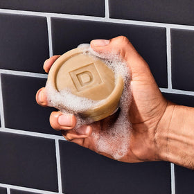Duke Cannon Bar Soap Puck in hand demonstrating easy handling