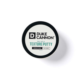 Duke Cannon Dry Hold Texture Putty on a bathroom shelf