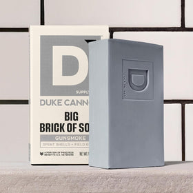 Duke Cannon Extra Large Bar Soap being lathered with a loofah