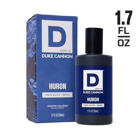 Duke Cannon Proper Cologne Huron on a wooden surface with nature background