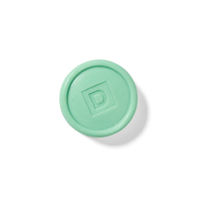 Duke Cannon soap puck displayed with grooming products