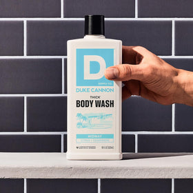 Duke Cannon Thick Body Wash with lather on a shower surface