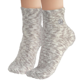 Earth Therapeutics Aloe Socks displayed on a wooden surface